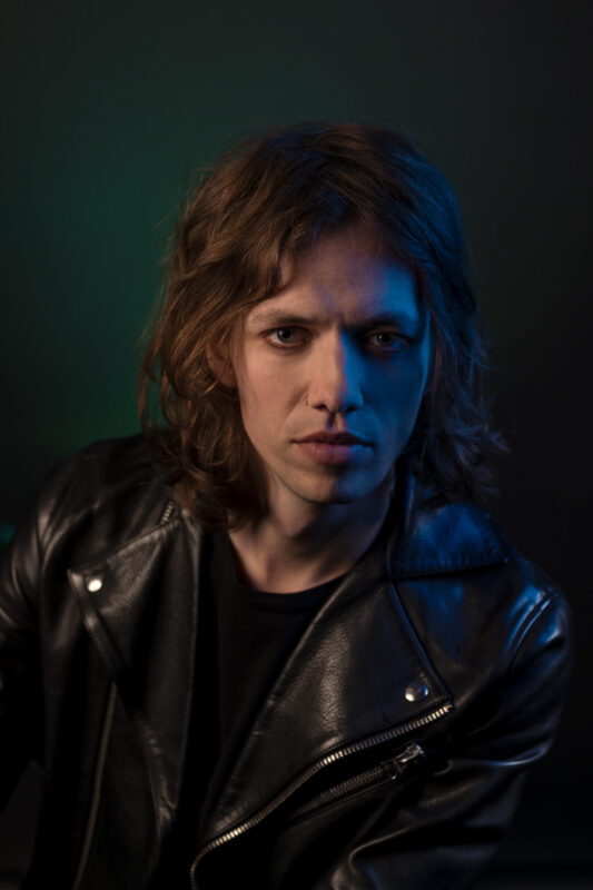 Carl Emil Petersen press photo long hair leather jacket Danish artist booking for parties and events